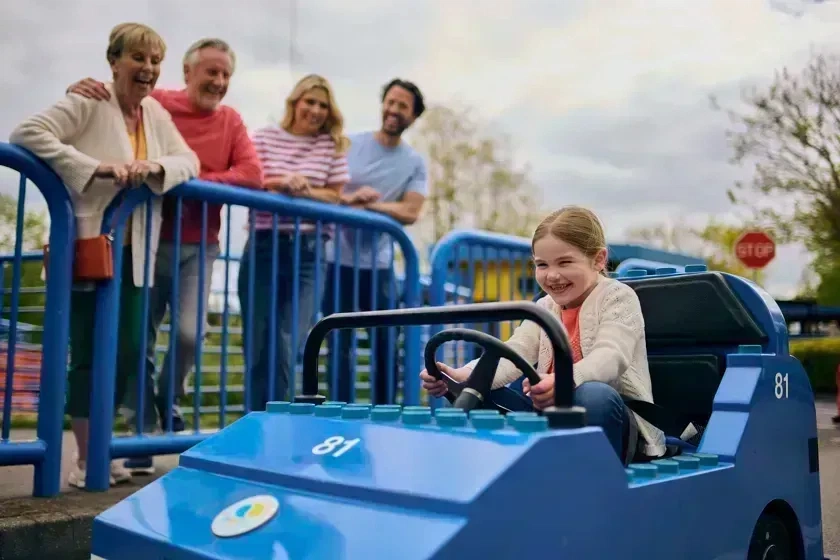 Young girl driving a LEGO City Car